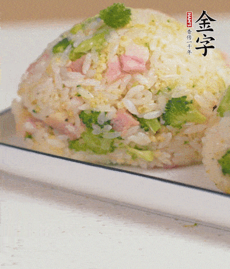 拌好的飯攥成飯團(tuán)。